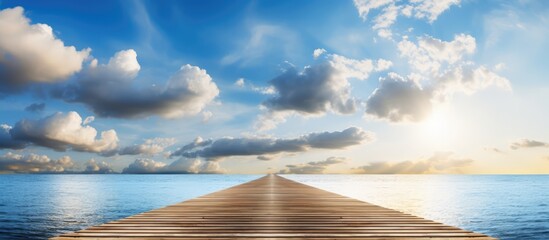 Sunny day with white clouds and sun shining over a wooden pier