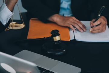 Consultation and conference of Male lawyers and professional businesswoman working and discussion having at law firm in office. Concepts of law, Judge gavel with scales of justice.