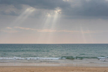 sunset on the beach,with lighting beams