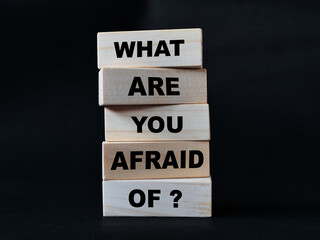 What are you afraid of, quote text written on wooden block, motivation inspiration