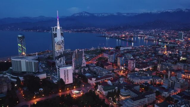 Scenic cityscape of town Batumi with illuminated Alphabetic Tower at spring evening, Georgia