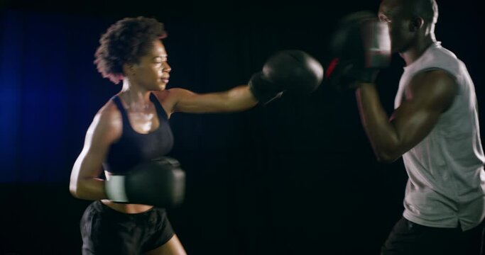 Boxing, gloves and fight for fitness with a black couple in studio on a dark background for health. Combat, self defense or sparring with a man and woman boxer in an exercise workout or training
