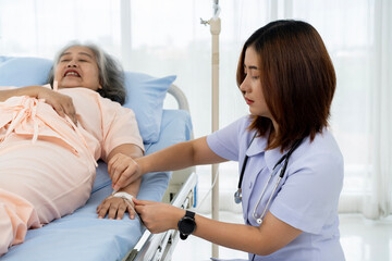 Nurse are verifying the accuracy of giving Saline to patients. Caregiver or nurse and senior...