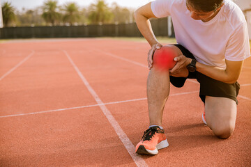 Fototapeta premium Fit man runner has twisted ankle injury while practice marathon run at the racetrack.