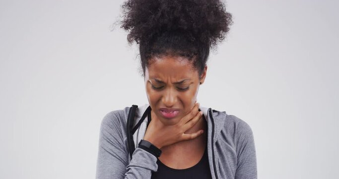 Woman, pain and sick with throat infection, sore and hand on neck, relief and virus. Allergy, flu and choking for strain, medical problem and health issue for bacteria, studio background and swollen