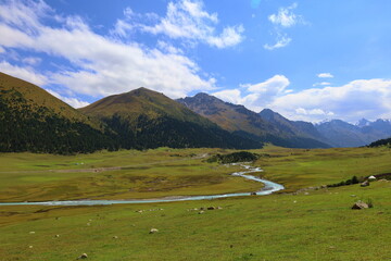 Turgenaksu valley with a river wading on a second stage of Ak-Suu Traverse trek in Karakol,...