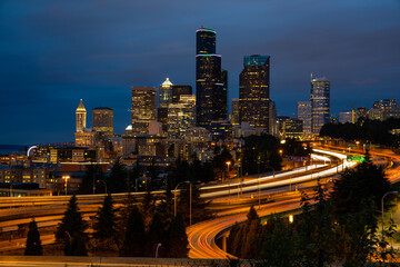 Fototapeta na wymiar Seatle Skyline In Evening With Light Trails From Cars 