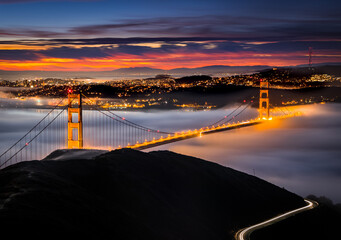 San Francisco Golden Gate Bridge at Sunrise Covered in Fog / Clouds