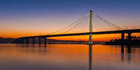 San Francisco / Oakland Bay Bridge During Colorful Sunrise 