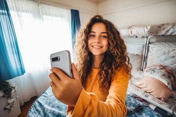 Beautiful young woman solo traveler taking a self portrait on her camera phone while smiling and enjoying vacation - obrazy, fototapety, plakaty