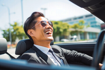 Successful older asian businessman driving cabriolet car on a sunny day, handsome gentleman driving around countryside