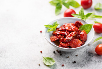 Bowl with sun dried tomatoes with fresh herbs and spices.