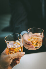 Close-up businessman holding a glass of whiskey