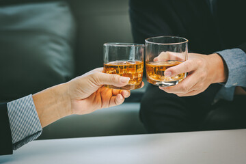 Close-up businessman holding a glass of whiskey