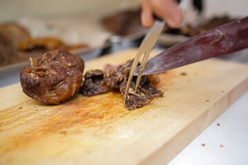 Fork and knife beef, cutting beef to make delicious Betawi soto