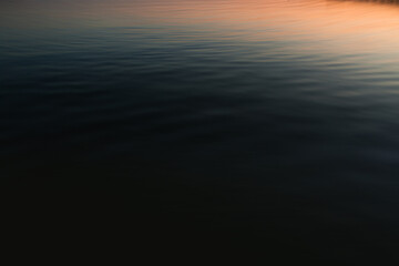 Calm lake with sunset light and colors