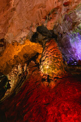 Cave illuminated with orange and red lights