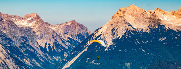Alpine summer view with a paraglider at Mount Seefelder Joch, Rosshuette,  Seefeld, Tyrol, Austria