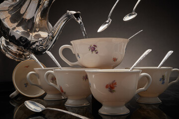 Teapot, teacups & silver spoons