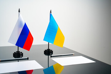 Russia and Ukraine flags on negotiation table