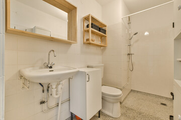 a bathroom with a sink, mirror and toilet paper dispensed on the wall next to the shower