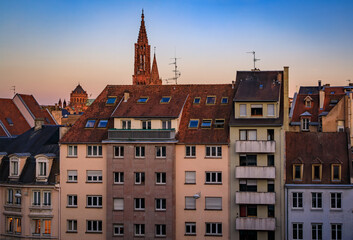 Grande Ile city skyline at sunset, tiled roofs and spires of Notre Dame Cathedral and Eglise du Temple Neuf church, Strasbourg, Alsace, France
