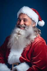 Santa Claus with white beard Smiling happily wearing a red Santa hat, Christmas blue snow background, holiday landscape banner