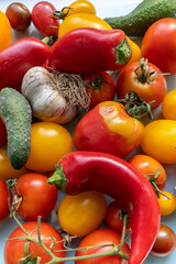 Fresh organic tomatoes and garlic, pepper, cucumbers, close-up image.