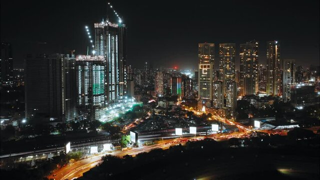 Aerial view of Central Mumbai's skyline at night. Mumbai lit up at night: Urban cityscape concept or abstract of advanced innovation, financial technology, energy power. Mahalaxmi station, Racecourse.