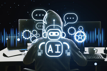 Back view of hacker using computers at desk with glowing robot ai hologram on dark background. Automated machine learning, hacking and artificial intelligence and conversation assistant concept.