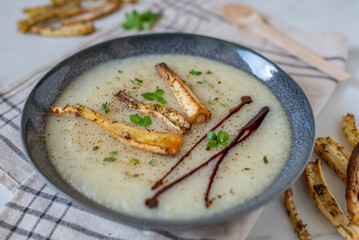 Bowls with tasty creamy soup of parsnip