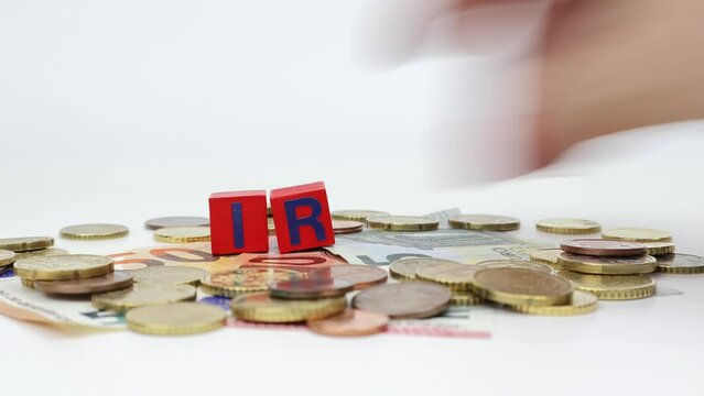 IRAP - A hand remove letters on blocks one by one to form tax on top of us euro money. Regional Tax on Productive Activities.