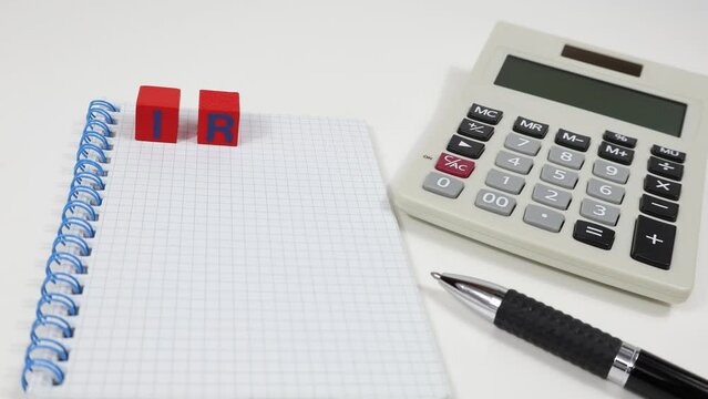 IRAP - A hand remove letters on blocks one by one to form tax on top of a notebook. Regional Tax on Productive Activities.