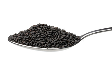 Metal spoon with roasted black sesame seed close up on white background