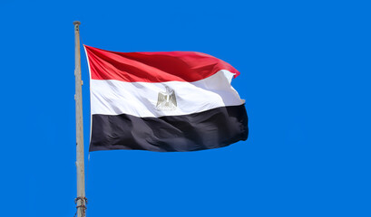 Flag of Egypt waving in the wind. Flag of the Arab Republic of Egypt on flagpole on blue sky background