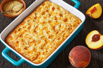peach cake in baking dish on dark wooden table