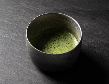 Matcha green tea on black background.