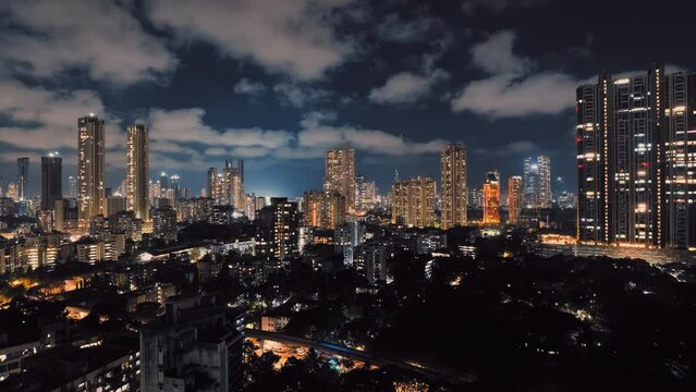 Modern City high-rise skyscraper buildings. Cloud-moving Timelapse view of Mumbai City at night: urban cityscape concept or abstract of advanced innovation, financial technology, and energy power.