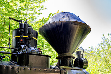 Chimney of old steam train engine machine, close up partial view, Serbia