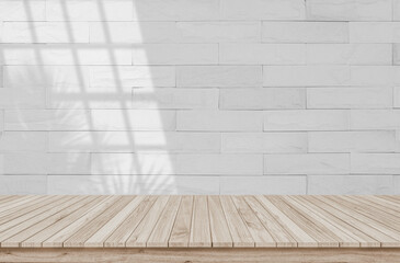 Minimalistic abstract gentle light white background for product presentation with light and shadow of window and leaf curtains on brick wall. White brick wall texture wall old on floor wood parquet.