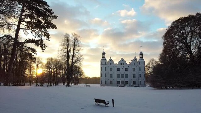 Drone shot, drone flight over Ahrensburg Castle in winter at sunrise, Schleswig Holstein, Germany, Europe