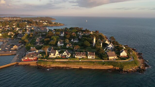 Drone shot, drone flight along the coast, beach, from the Atlantic Ocean to the port of Port Navalo in Arzon in the evening light, marina with sailboats, department of Morbihan, Brittany, France