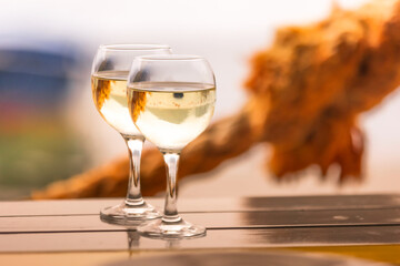 Two glasses of white wine on wooden table