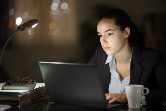 Serious businesswoman working in the night