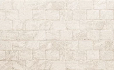 Photo sur Aluminium Mur de briques Empty background of wide cream brick wall texture. Beige old brown brick wall concrete or stone textured, wallpaper limestone abstract flooring. Grid uneven interior rock. Home decor design backdrop.