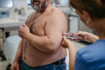 Female doctor measuring body fat of overweight patient using a caliper. Obesity affecting middle-aged men's health. Concept of health risks of overwight and obesity.