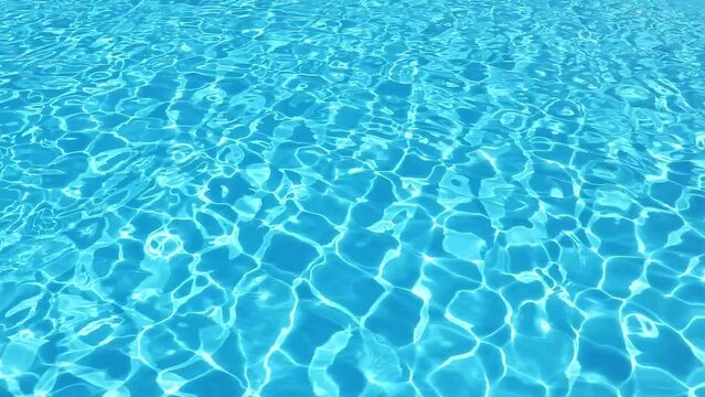 Water surface texture, Slow motion clean swimming pool ripples and wave, Refraction of sunlight top view texture sea side, sun shine water background. Water Caustic Background