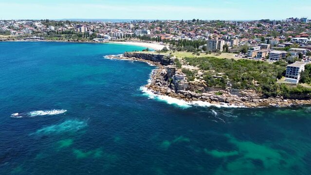 Drone aerial landscape nature cliff face coastline view rocky headland Gordons Bay Clovelly Coogee Beach Sydney housing market suburb ocean surf NSW travel tourism Australia 4K