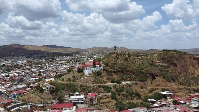 Drone shot of a city in the countryside moving away to have more vision of the shot