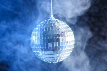 Disco ball in smoke on a dark background